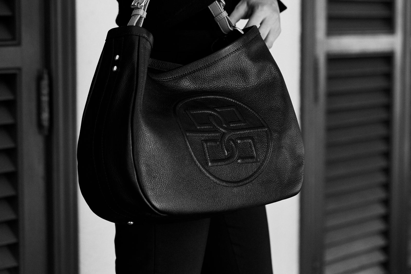 A leather bag with an embossed Bolvaint monogram